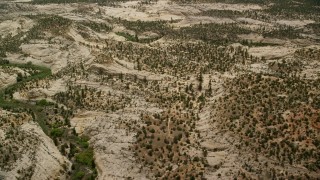 AX130_382 - 5.5K aerial stock footage of flying by hills, desert vegetation, trees, Grand Staircase-Escalante National Monument, Utah