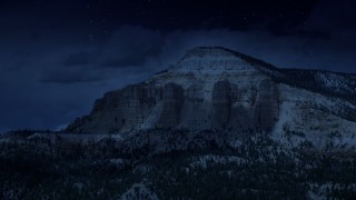 AX130_401_DFN - Aerial stock footage of 4K day for night color corrected aerial footage of flying by the side of a mesa, Barney Top Mesa, Utah