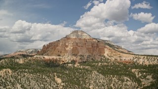 5.5K aerial stock footage of flying by mesa, with desert vegetation, trees in the foreground, Barney Top Mesa, Utah Aerial Stock Footage | AX130_402E