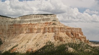 AX130_406 - 5.5K aerial stock footage of a mesa with desert vegetation and trees in the foreground, Barney Top Mesa, Utah