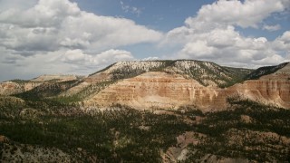 5.5K aerial stock footage of a view of a mesa with desert vegetation and trees in the foreground, Barney Top Mesa, Utah Aerial Stock Footage | AX130_407