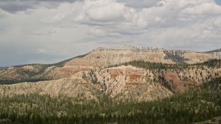 5.5K aerial stock footage of passing by mesa with desert vegetation in the foreground; Barney Top Mesa, Utah Aerial Stock Footage | AX130_409E