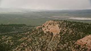 5.5K aerial stock footage of flying by radio towers on a ridge, dry lake in background, Bryce Canyon National Park, Utah Aerial Stock Footage | AX130_422E