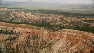 5.5K aerial stock footage of passing steep mesa slopes, trees, desert vegetation; Bryce Canyon National Park, Utah Aerial Stock Footage | AX130_426