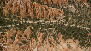 AX130_433E - 5.5K aerial stock footage bird's eye view of hoodoos, buttes, dirt roads, dry riverbed, Bryce Canyon National Park, Utah