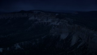 AX131_026_DFN - Aerial stock footage of 4K day for night color corrected aerial footage approach and flyby rock formations, Pink Cliffs, Bryce Canyon National Park, Utah