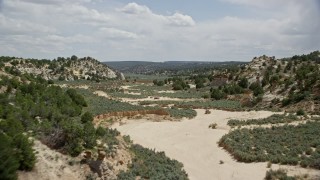 5.5K aerial stock footage of flying over the edge of dry riverbed, Grand Staircase-Escalante National Monument, Utah Aerial Stock Footage | AX131_062E