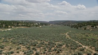 AX131_065E - 5.5K aerial stock footage fly over hills and trees, Grand Staircase-Escalante National Monument, Utah