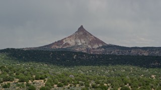 AX131_067E - 5.5K aerial stock footage of passing by Mollies Nipple peak, Grand Staircase-Escalante National Monument, Utah