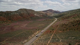 AX131_088E - 5.5K aerial stock footage track a car on Highway 89, Glen Canyon National Recreation Area, Utah, Arizona