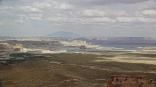 5.5K aerial stock footage of passing Lone Rock and Lake Powell by Glen Canyon National Recreation Area, Utah, Arizona Aerial Stock Footage | AX131_122