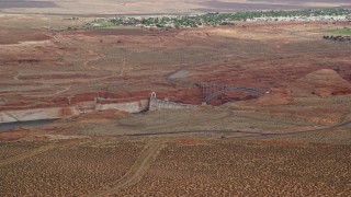 AX131_131E - 5.5K aerial stock footage of passing by Glen Canyon Dam and Bridge, Arizona