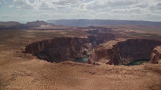 5.5K aerial stock footage of flying by Horseshoe Bend, then away from Colorado River, Glen Canyon, Arizona Aerial Stock Footage | AX131_161E