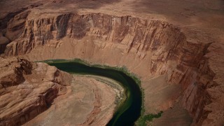 5.5K aerial stock footage of flying away from Horseshoe Bend and the Colorado River in Glen Canyon, Arizona Aerial Stock Footage | AX131_169E