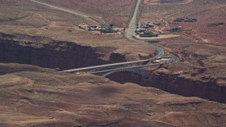 5.5K aerial stock footage of a view of Navajo Bridge spanning Marble Canyon, Glen Canyon National Recreation Area, Utah, Arizona Aerial Stock Footage | AX131_196E