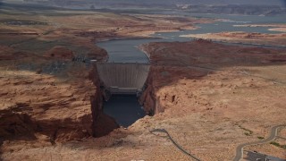 AX131_223E - 5.5K aerial stock footage of flying by roads near the Glen Canyon Dam and Bridge, Arizona