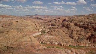 5.5K aerial stock footage approach and flyby canyons in the Navajo Nation Reservation, Navajo Creek, Arizona Aerial Stock Footage | AX131_243