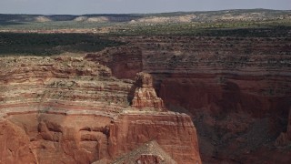 5.5K aerial stock footage of flying by rock formation, near mesa, Navajo Nation Reservation, Arizona Aerial Stock Footage | AX132_013