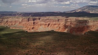 5.5K aerial stock footage of approaching wide canyon and distant mesa, Navajo Nation Reservation, Utah Aerial Stock Footage | AX132_016