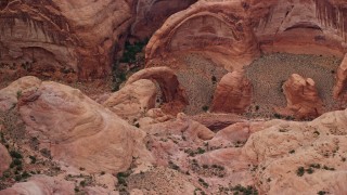 AX132_037E - 5.5K aerial stock footage of flying by mesa, revealing stone bridge, Rainbow Bridge National Monument, Utah