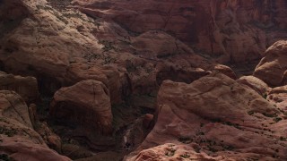 AX132_056E - 5.5K aerial stock footage of focusing on a stone arch, Rainbow Bridge National Monument, Utah