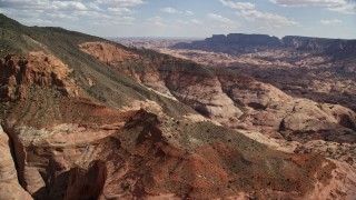 AX132_063E - 5.5K aerial stock footage of flying toward mountain peaks and slopes, Navajo Mountain, Utah