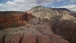 AX132_069E - 5.5K aerial stock footage of flying by mountain peak, slopes, Navajo Mountain, Utah