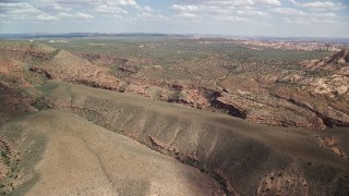 5.5K aerial stock footage of passing by narrow desert canyon, Navajo Nation Reservation, Arizona, Utah Aerial Stock Footage | AX132_071E