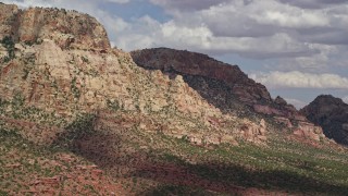 5.5K aerial stock footage of flying by a mountain peak with rocky slopes, Navajo Mountain, Utah Aerial Stock Footage | AX132_073E