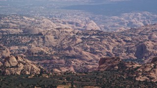 5.5K aerial stock footage of lying by desert mountain ridges in Navajo Nation Reservation, Arizona, Utah Aerial Stock Footage | AX132_075E