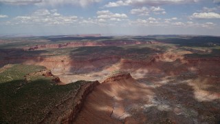 5.5K aerial stock footage of approaching a desert canyon and mesas at Navajo Nation Reservation, Arizona, Utah Aerial Stock Footage | AX132_080