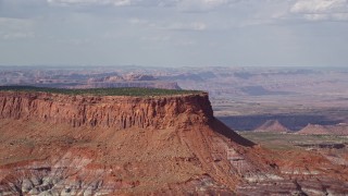 5.5K aerial stock footage of passing by a tall desert mesa, Navajo Nation Reservation, Arizona, Utah Aerial Stock Footage | AX132_092E