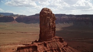 5.5K aerial stock footage of circling a tall butte surrounded by mesas, Navajo Nation Reservation, Arizona, Utah Aerial Stock Footage | AX132_105E