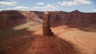 5.5K aerial stock footage fly around a tall butte in desert valley, Navajo Nation Reservation, Arizona, Utah Aerial Stock Footage | AX132_108E