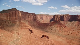 5.5K aerial stock footage orbit around a lone desert butte near mesas, Navajo Nation Reservation, Arizona, Utah Aerial Stock Footage | AX132_111E