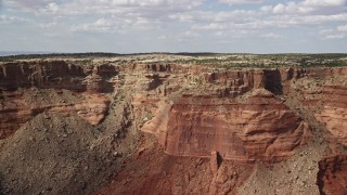 5.5K aerial stock footage pan across top of a desert mesa and Monument Valley, Navajo Nation Reservation, Arizona, Utah Aerial Stock Footage | AX132_118E