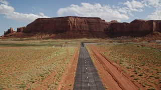 5.5K aerial stock footage of approaching airport by Rock Door Mesa, Monument Valley Airport, Utah Aerial Stock Footage | AX132_136