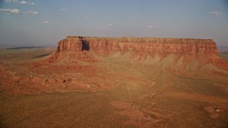 AX133_004E - 5.5K aerial stock footage of flying by Eagle Mesa in Monument Valley, Utah, Arizona, sunset