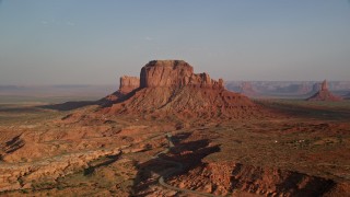 5.5K aerial stock footage of Brighams Tomb Butte, Monument Valley, Utah, Arizona, sunset Aerial Stock Footage | AX133_011E