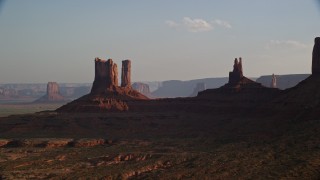 5.5K aerial stock footage of flying by buttes, desert valley, Monument Valley, Utah, Arizona, sunset Aerial Stock Footage | AX133_014