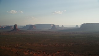 5.5K aerial stock footage of a view of buttes and mesas across desert valley, Monument Valley, Utah, Arizona, twilight Aerial Stock Footage | AX133_020