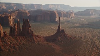 AX133_038E - 5.5K aerial stock footage of orbiting Totem Pole Butte, Monument Valley, Utah, Arizona, twilight