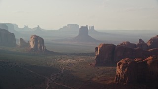 5.5K aerial stock footage of flying past mesas and buttes in Monument Valley, Utah, Arizona, twilight Aerial Stock Footage | AX133_049E