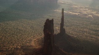 5.5K aerial stock footage of flying away from Totem Pole Butte, Monument Valley, Utah, Arizona, twilight Aerial Stock Footage | AX133_051