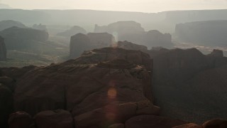 5.5K aerial stock footage of a view of Monument Valley mesas and buttes, Utah, Arizona, sunset Aerial Stock Footage | AX133_052