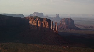 5.5K aerial stock footage of passing buttes in a desert valley, Monument Valley, Utah, Arizona, twilight Aerial Stock Footage | AX133_068