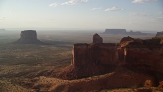 5.5K aerial stock footage of flying by mesa, approaching buttes in Monument Valley, Utah, Arizona, twilight Aerial Stock Footage | AX133_075