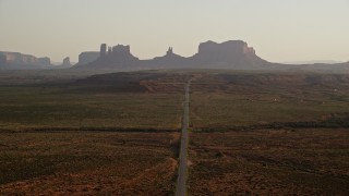 5.5K aerial stock footage fly over highway and approach buttes, Monument Valley, Utah, Arizona, twilight Aerial Stock Footage | AX133_107E