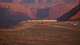 5.5K aerial stock footage of flying by The View Hotel, Monument Valley, Utah, Arizona, sunset Aerial Stock Footage | AX133_160