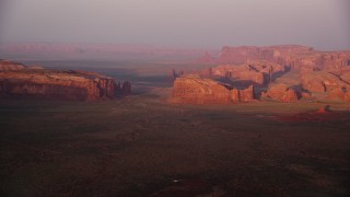 5.5K aerial stock footage of buttes and mesas in Monument Valley, Utah, Arizona, sunset Aerial Stock Footage | AX133_176